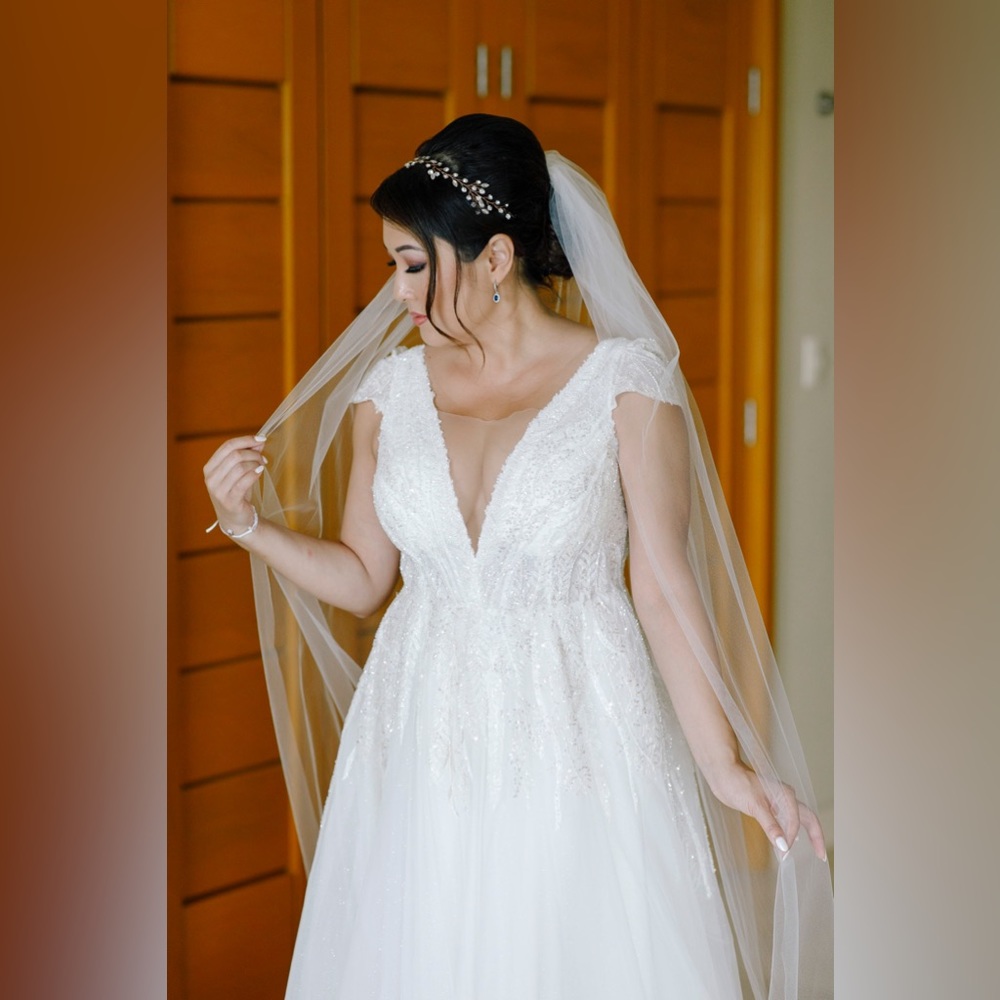 Ivory wedding gown with intricate beading on the upper half of the gown. Size 8